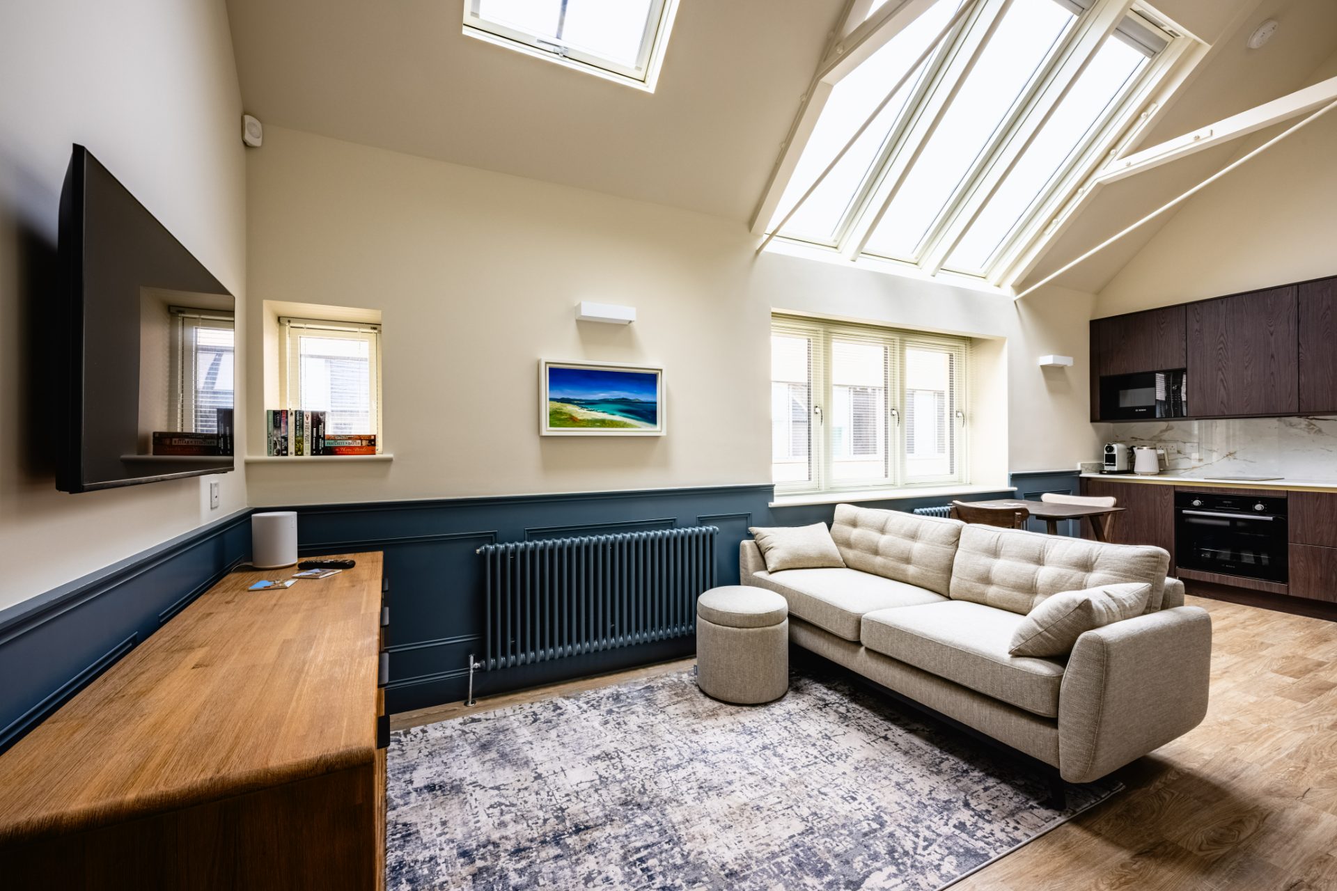 Inside North Lane Mews — vaulted ceiling and rooflights, navy panelling and warm oak floors
